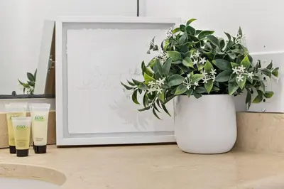 a white vase with a plant in front of a microwave at Las Olas Blvd Exclusive Apt with waterview in Fort Lauderdale