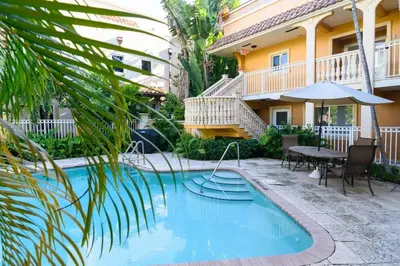 a swimming pool with a table and a house at Las Olas Blvd Exclusive Apt with waterview in Fort Lauderdale