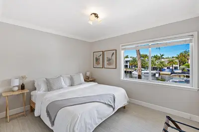 a white bedroom with a large bed and a window at Relaxing Beach Apt in las Olas Blvd in Fort Lauderdale