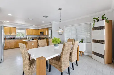 a kitchen and dining room with a white table and chairs at Relaxing Beach Apt in las Olas Blvd in Fort Lauderdale