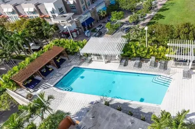 an overhead view of a swimming pool with chairs and trees at Coco Loco - Wynwood in Miami