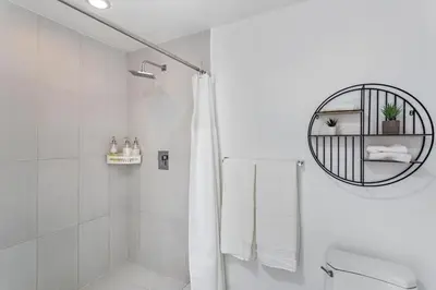 a white bathroom with a shower and a toilet at Coco Loco - Wynwood in Miami