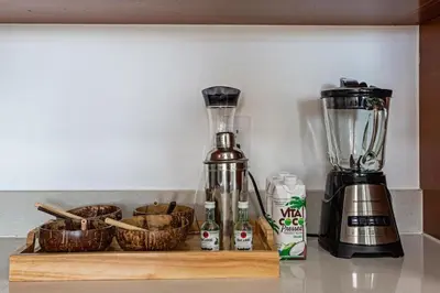 a kitchen counter with a blender and baskets on a shelf at Coco Loco - Wynwood in Miami