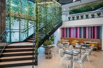 a staircase in a restaurant with tables and chairs at Huge Studio POOL & GYM - Explore Miami's Heat in Miami