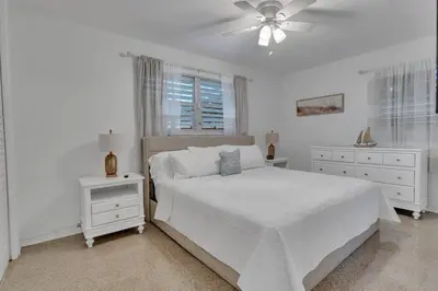 a white bedroom with a bed and a ceiling fan at 7-Person Luxury Spa, Fenced Paradise, Beach Vibes in Pembroke Pines