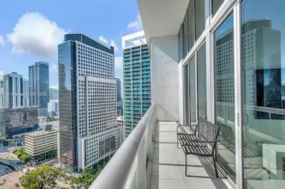 a balcony with two chairs and a view of a city at 28th Floor Icon Brickell Penthouse with City Views in Miami