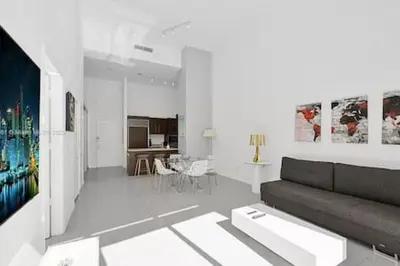 a white living room with a couch and a table at 28th Floor Icon Brickell Penthouse with City Views in Miami