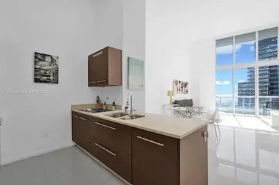 a kitchen with a sink and a large window at 28th Floor Icon Brickell Penthouse with City Views in Miami