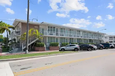 a large building with cars parked in front of it at North Shore Oasis - Steps to Miami Beach Bliss in Miami Beach