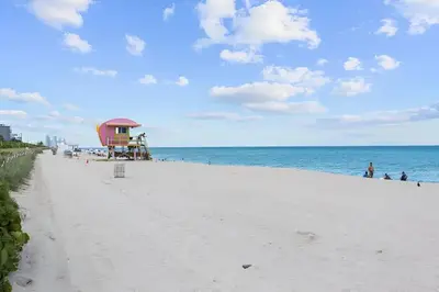 a beach with a life guard shack and the ocean at North Shore Oasis - Steps to Miami Beach Bliss in Miami Beach