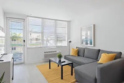 a living room with a couch and a table at North Shore Oasis - Steps to Miami Beach Bliss in Miami Beach