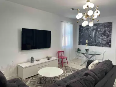 a living room with a couch and a table at ZION Miami Design District 2 Bedroom amongst the trees! in Miami