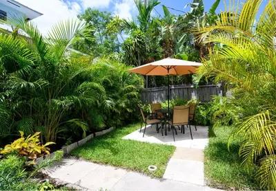 a patio with a table and an umbrella at Bright & Comfortable Apt in Victoria Park in Fort Lauderdale