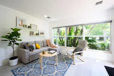 a living room with a couch and a table at Bright & Comfortable Apt in Victoria Park in Fort Lauderdale