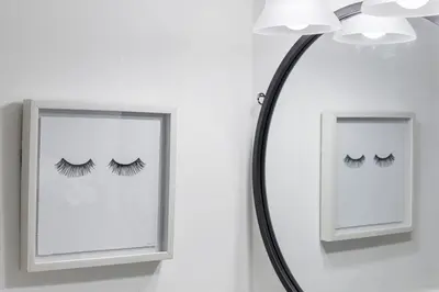 a mirror with lashes on it next to a lamp at Lake Ridge Villa in Fort Lauderdale