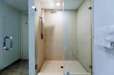 a bathroom with a shower with a glass door at Ocean & City Views l Luxury Beachfront Condo in Hollywood