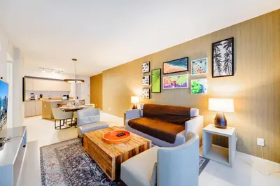 a living room with a couch and a table at Ocean & City Views l Luxury Beachfront Condo in Hollywood