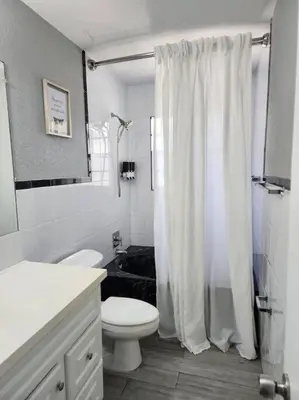 a white bathroom with a toilet and a shower at The Perfect Vacation Getaway ! in Miami