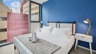 a bedroom with a large bed and a large window at Sentral Alea Miami in Miami