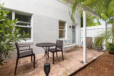a patio with a table and chairs in front of a house at Dreamy 1-bedroom apt walking distance to Las Olas in Fort Lauderdale