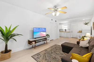 a living room with a couch and a flat screen tv at Dreamy 1-bedroom apt walking distance to Las Olas in Fort Lauderdale