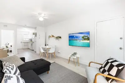a living room with a couch and a table at Charming 2 Bedroom Apartment in Victoria Park in Fort Lauderdale