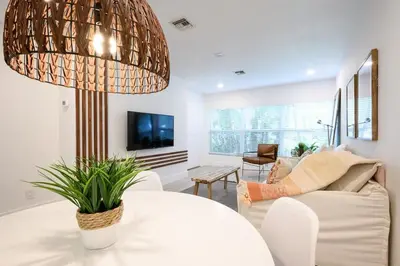 a living room with a large chandelier at Beautiful And Comfortable Apt in Victoria Park in Fort Lauderdale