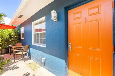 a colorful house with a orange door and a table at Lovely 2 BR condo with free parking on premises in Fort Lauderdale