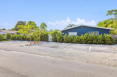 a parking lot in front of a blue building at Lovely 2 BR condo in Sailboat Bend in Fort Lauderdale