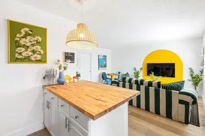 a kitchen with a wooden counter top and chairs at Lovely 2 BR condo in Sailboat Bend in Fort Lauderdale