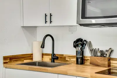 a kitchen counter with a sink and a microwave at Beautiful 2 BR Apartment - Bright and Spacious in Fort Lauderdale
