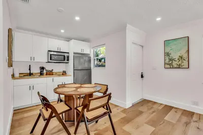 a kitchen and dining room with a table and chairs at Beautiful 2 BR Apartment - Bright and Spacious in Fort Lauderdale