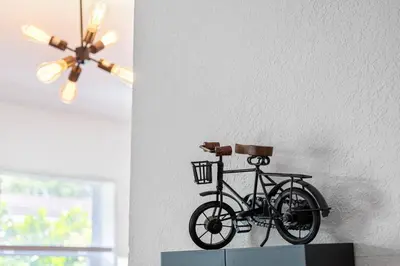 a bike hanging on a wall with a ceiling fan at Musicians Lounge - 2 BR with parking asssigned in Fort Lauderdale