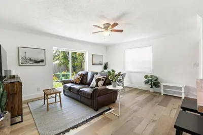 a living room with a couch and a ceiling fan at Bright and Spacious 2 BR Apartment in Fort Lauderdale