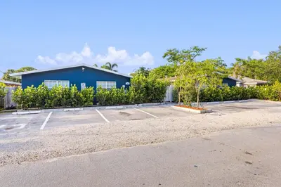 a parking lot in front of a blue building at Stylish 2 BR condo - close to Riverwalk in Fort Lauderdale