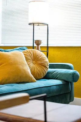 a blue couch with a pillow and a lamp at The Yellow Submarine @Sailboat Bend in Fort Lauderdale