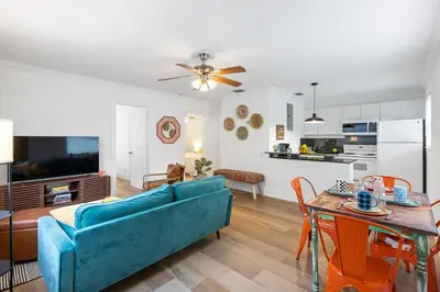 a living room with a blue couch and a table at The Yellow Submarine @Sailboat Bend in Fort Lauderdale