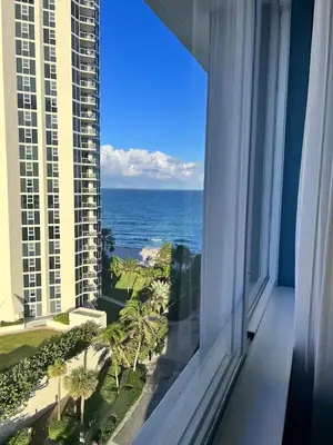 a view of the ocean from a window of a building at Entire Condo in Sunny Isles in Sunny Isles Beach