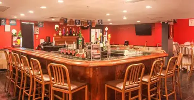 a bar with a bunch of chairs around it at Entire Condo in Sunny Isles in Sunny Isles Beach