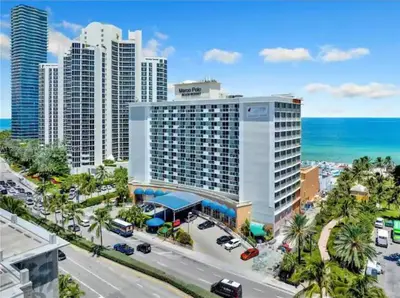 an aerial view of a large building near the ocean at Entire Condo in Sunny Isles in Sunny Isles Beach