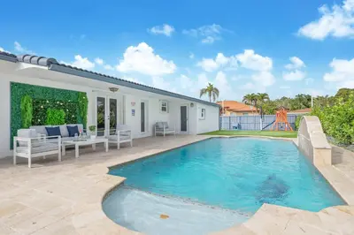 a swimming pool in the backyard of a house at Le Femme Paradise -Htd Pool, Mini Golf, 5 Bedrooms, Jacuzzi, Game Room, BBQ,Pickleball in Miami