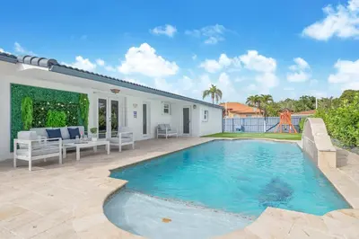 a swimming pool in the backyard of a house at Le Femme Paradise -Htd Pool, Mini Golf, 5 Bedrooms, Jacuzzi, Game Room, BBQ,Pickleball in Miami