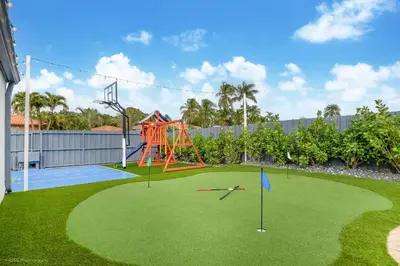 a playground with an orange slide and a playground at Le Femme Paradise -Htd Pool, Mini Golf, 5 Bedrooms, Jacuzzi, Game Room, BBQ,Pickleball in Miami