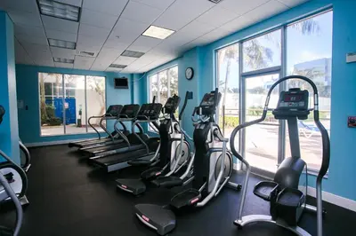 a gym with a row of cardio machines in a room at LUXURY PENTHOUSE ON THE BEACH 3/3 OCEANFRONT CONDO in Hollywood
