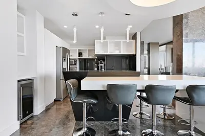 a kitchen with a white counter and gray chairs at LUXURY PENTHOUSE ON THE BEACH 3/3 OCEANFRONT CONDO in Hollywood