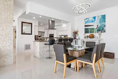 a dining room and kitchen with a table and chairs at Oceanfront Luxury Penthouse On The Beach 3 Bedroom in Hollywood