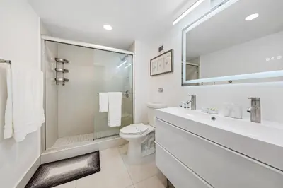 a white bathroom with a sink and a toilet at Oceanfront Luxury Penthouse On The Beach 3 Bedroom in Hollywood