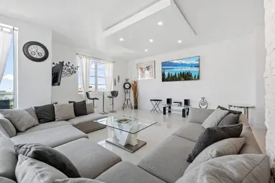 a living room with a couch and a table at Oceanfront Luxury Penthouse On The Beach 3 Bedroom in Hollywood