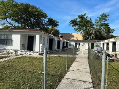 a fence in front of a house at Villa Clara SUITE - Little Havana in Miami
