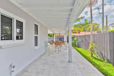 a patio with a table and chairs on it at Spacious 4 bedrooms, 2 bathroom house with pool in Miramar